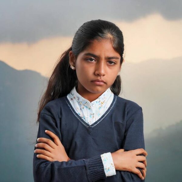 A-12-year-old-angry-indian-girl-standing-feeling-unfair-with-stiffness-in-body-arms-and-tea