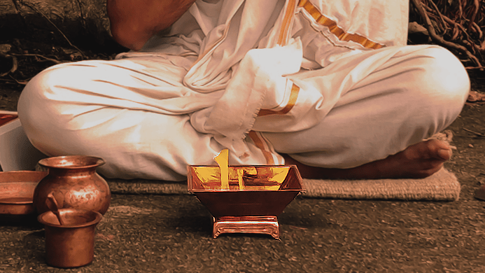 Person performing Agnihotra using the Agnihotra Kit